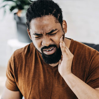 Man experiencing tooth pain