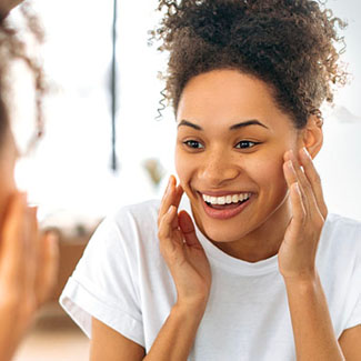 Woman admiring her smile in the mirror